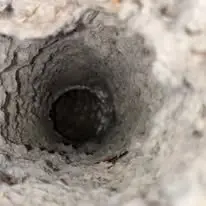 Clogged dryer vent before cleaning — lint buildup is a leading fire hazard.