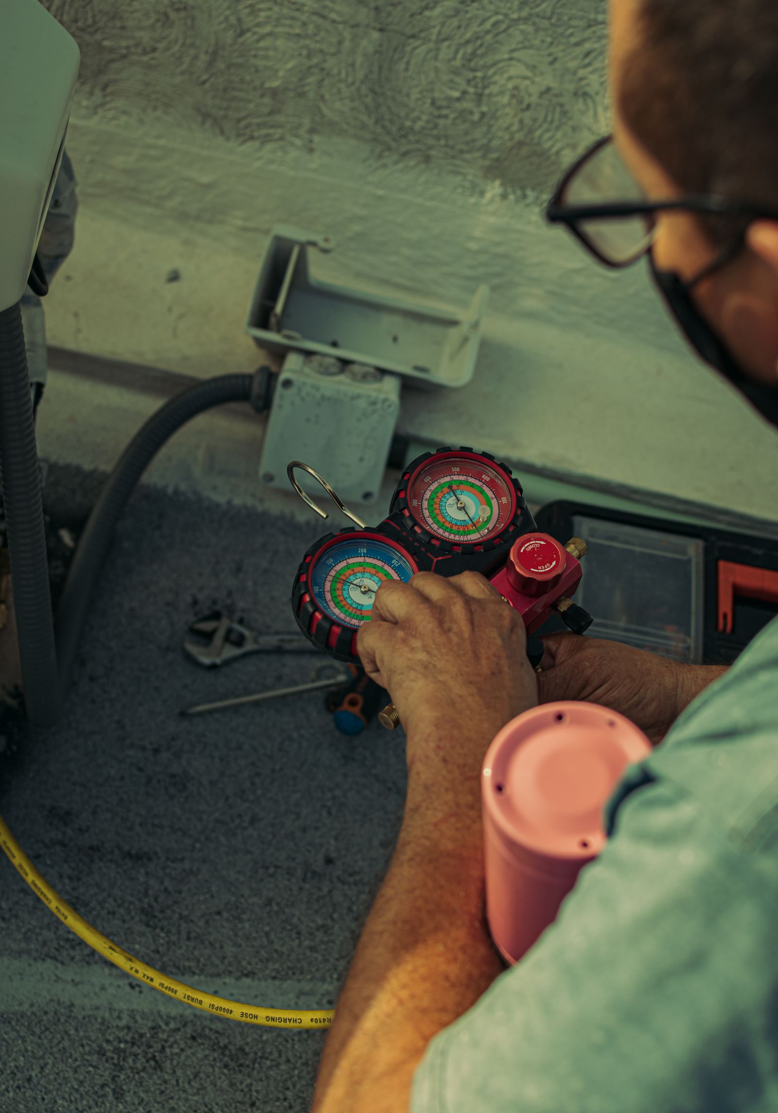 Refrigerant manifold gauge pressure check during HVAC maintenance service in Birmingham AL