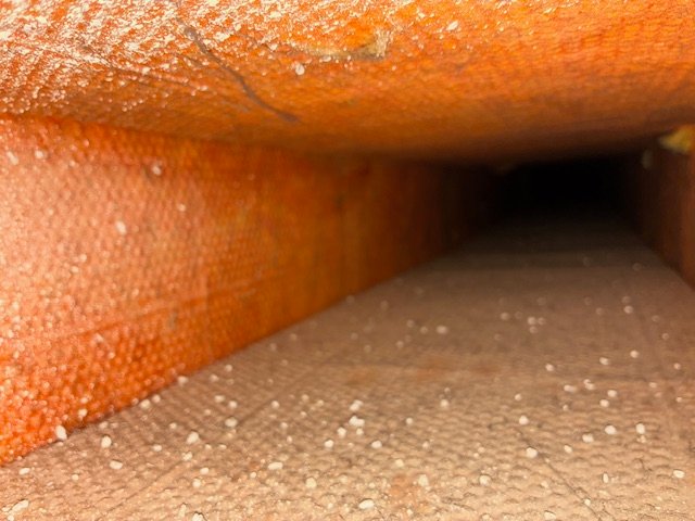 Dusty HVAC duct interior with loose particle buildup before Dust Lift service