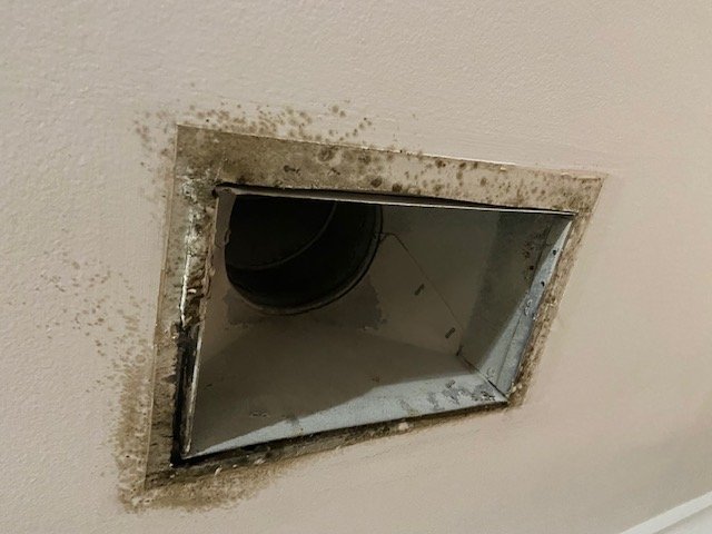 Ceiling register with dark spotting from attic air infiltration, before sealing, Hoover, AL