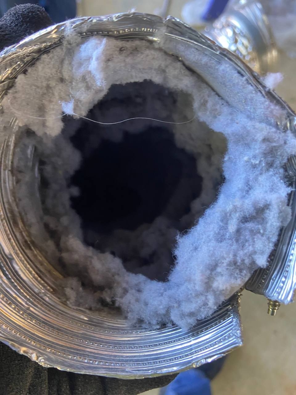 Dryer vent heavily clogged with lint before cleaning by DUCTS